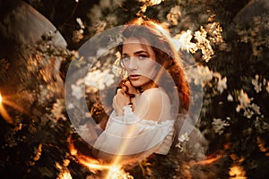 Portrait of a romantic girl, like a forest fairy, in a blooming garden with elements of phantasmagoria. The concept of