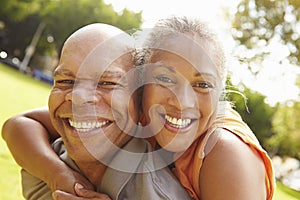 Portrait Of Romantic Senior Couple Relaxing In Park