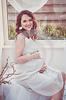 Portrait of romantic smiling pregnant woman