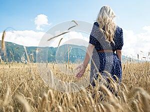 Portrait of romantic woman running across field