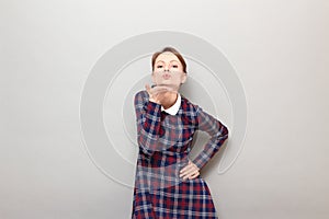 Portrait of romantic young woman blowing air kiss to you