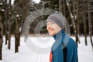 Portrait of a runner from the back, dressed in warm sportswear and preparing to run