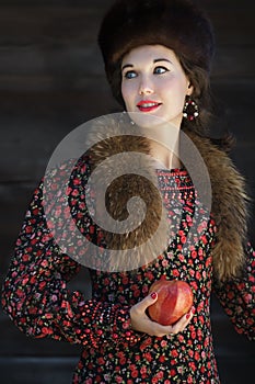 Portrait of Russian fashion style woman with red apple in arm