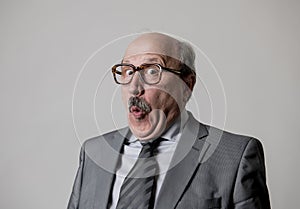 Portrait of 60s bald senior happy business man gesturing funny and comic in laughter and fun face expression looking happy photo