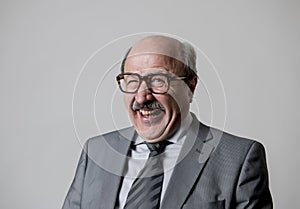 Portrait of 60s bald senior happy business man gesturing funny and comic in laughter and fun face expression looking happy