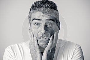 Portrait of a 40s 50s man in shock with a scared expression on his face making frightened gestures in human emotions feelings and