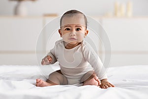 Portrait of sad African American baby crying alone