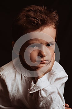 portrait of a sad angry child preschooler boy