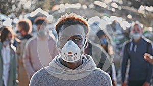 Portrait of a Sad Black Young Man in Gas Mask Standing in Toxic Smoke. Saving the Planet.