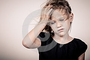 Portrait of sad blond little girl