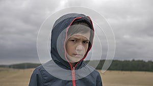 Portrait of a sad boy in autumn outdoors close up