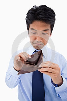 Portrait of a sad businessman showing his empty wallet