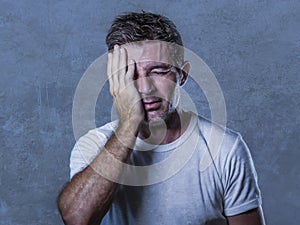 portrait of sad and depressed man with hand on face looking desperate feeling frustrated and helpless in depression and sadness f