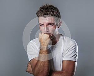 Portrait of sad and depressed man with hand on face looking desperate feeling frustrated and helpless in depression and sadness fa
