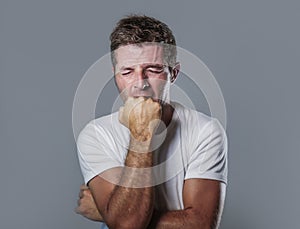 Portrait of sad and depressed man with hand on face looking desperate feeling frustrated and helpless in depression and sadness fa