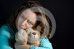 Portrait of a sad girl with teddy bear