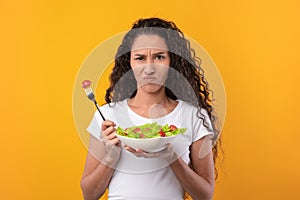 Portrait of Sad Latin Lady Holding Plate With Vegetable Salad