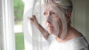 A portrait of sad lonely pensive old senior woman