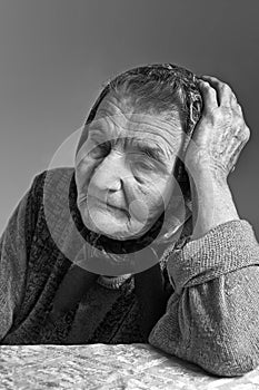 Portrait of sad lonely pensive old senior woman.