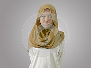 Portrait of sad muslim teenage girl looking at camera