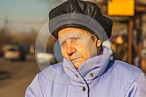 Portrait of sad old woman in the city