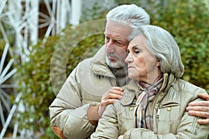 Portrait of sad senior couple in park