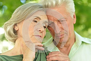 Portrait of sad senior couple in park