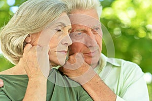 Portrait of sad senior couple in park