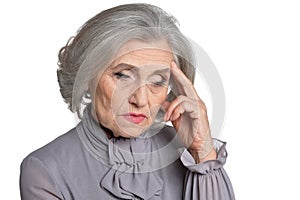 Portrait of sad senior woman on white background