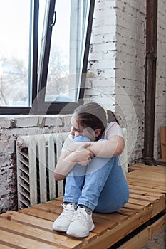 Portrait of   sad teenage girl against   wall