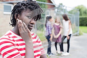 Portrait Of Sad Teenage Girl Feeling Left Out By Friends