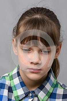 Portrait of a sad ten-year-old girl of European appearance, close-up