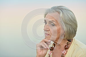 Portrait of sad, thoughtful senior woman in park