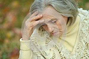 Portrait of sad, thoughtful senior woman in park