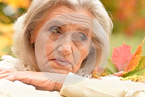 Portrait of sad, thoughtful senior woman in park