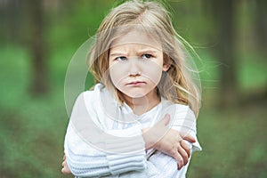 Portrait of sad unhappy little girl. Little sad child is lonesome. upset and distraught angry facial expression.