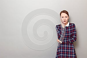 Portrait of sad unhappy shocked girl with widened eyes and open mouth