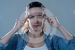 Portrait of sad woman in pain having headache and migraines