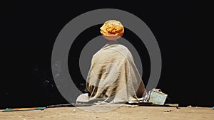 Portrait of sadhu or holy man praying and meditating on Ghats of Varanasi in front of the sacred river Ganges, India