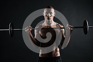 Portrait of a safro american sports man doing exercises with bar
