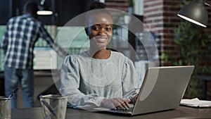 Portrait of sales assistant working on laptop to create capital profit