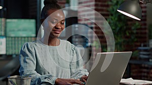 Portrait of sales assistant working on laptop to create capital profit