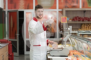 Portrait of a Salesman at Display in Supermarket