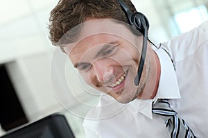 Portrait of salesman working on computer