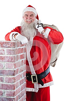 Portrait of santa claus carrying bag full of gifts