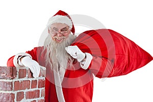 Portrait of santa claus carrying bag full of gifts