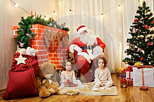 Portrait of Santa Claus and girl twin babies,child in the room b