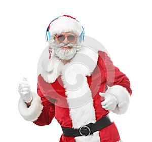 Portrait of Santa Claus listening to music and dancing on white background