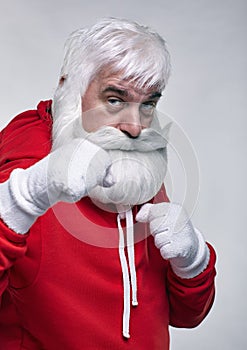 Portrait of a Santa Claus in sportsware boxing