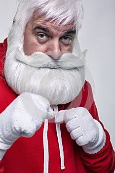 Portrait of a Santa Claus in sportsware boxing